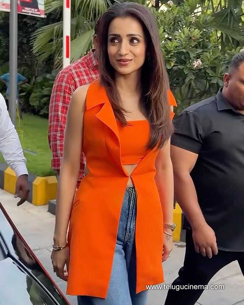 Trisha stuns in a tangerine-hued top