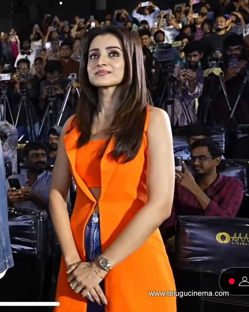 Trisha stuns in a tangerine-hued top